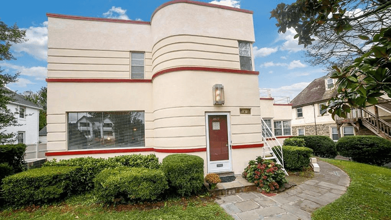 A two story Art Deco home, in off-white and brown trim, surrounded in greenery, located at 1234 House Lane, Langsley, VA 90210 and listed for $650,000.