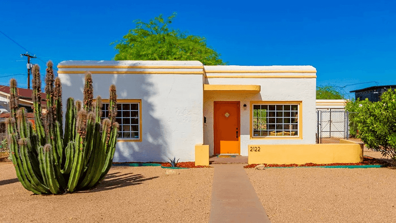 A one story Art Deco home, in white with yellow trim and a zero-scape yard, located at 1234 House Lane, Langsley, VA 90210 and listed for $650,000.